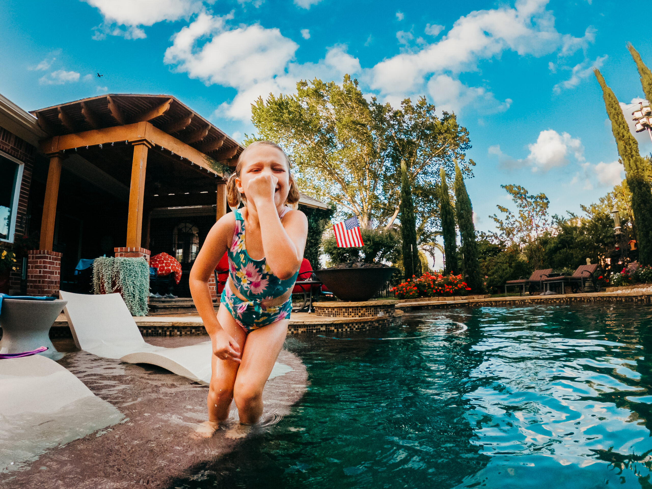 Child jumping into the pool during summer!
