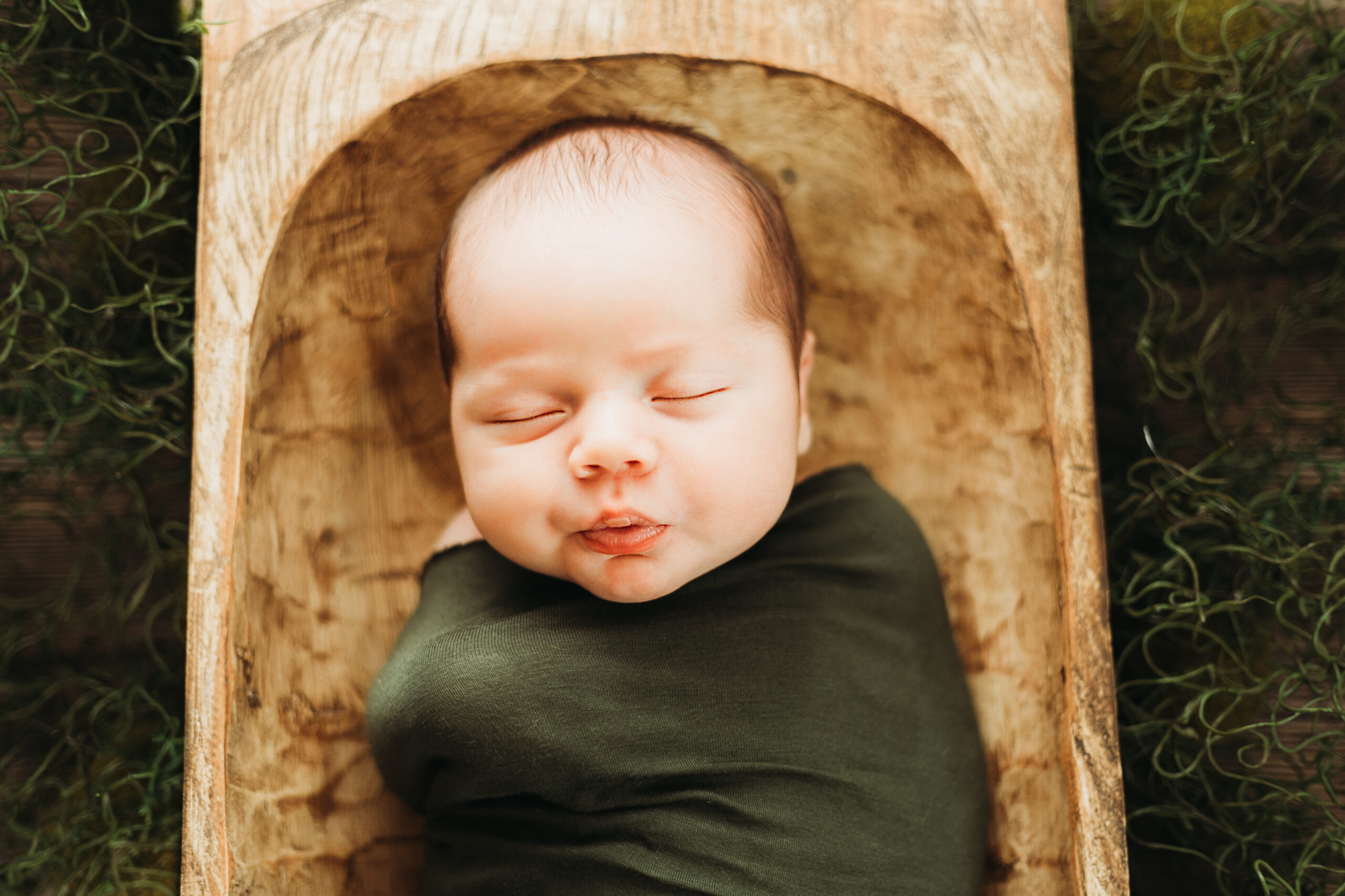 finding a lactation consultant in Houston yields a lot of choices, but Leah Jolly is the go to for this newborn sleeping in a dough bowl with olive green accents.