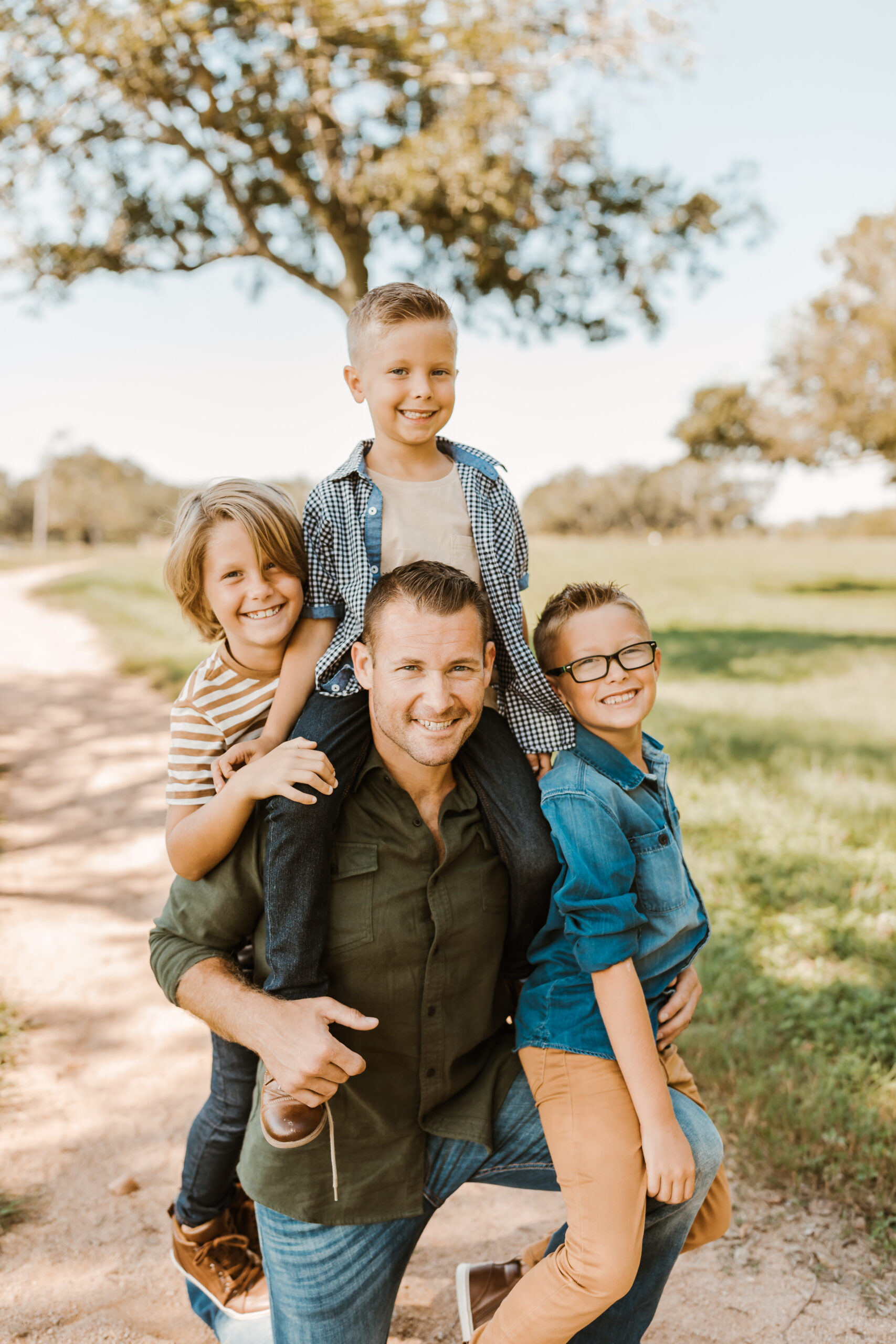 Dad and his 3 sons who use Just Between Friends Pearland to save on clothes for the kids.