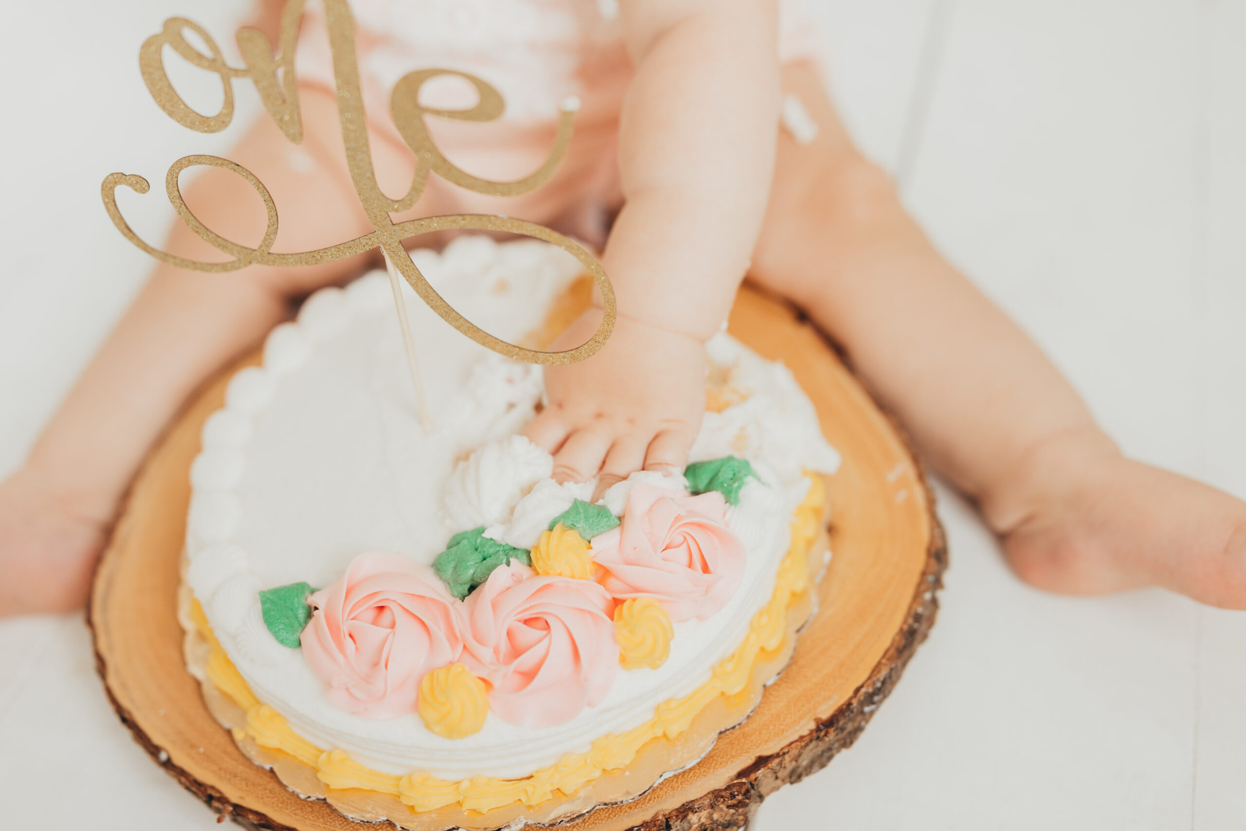 Up close picture of baby's first birthday cake, in studio with ally's photography