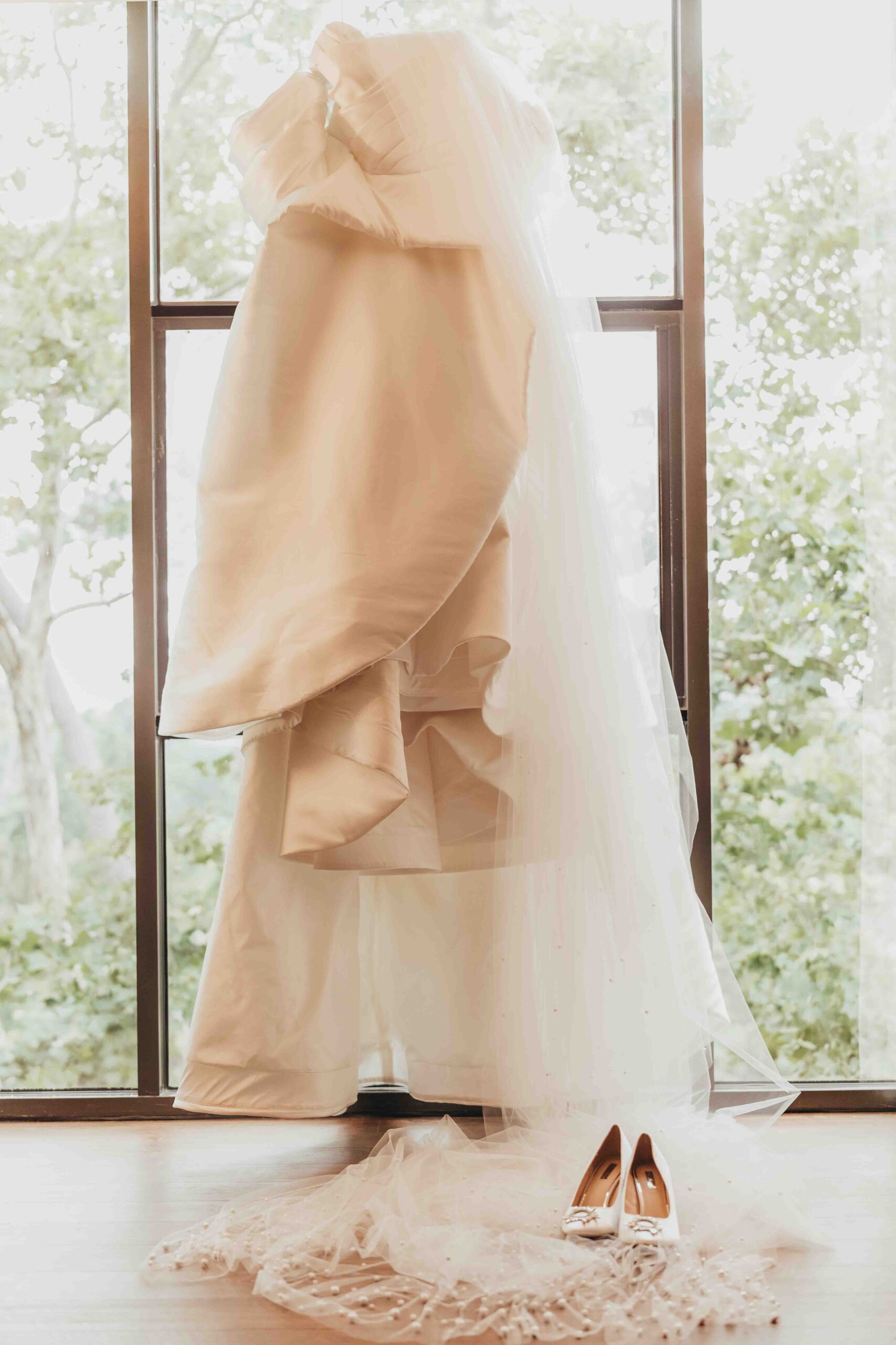 wedding gown hanging from the Houstonian Spa window, by Ally's Photography
