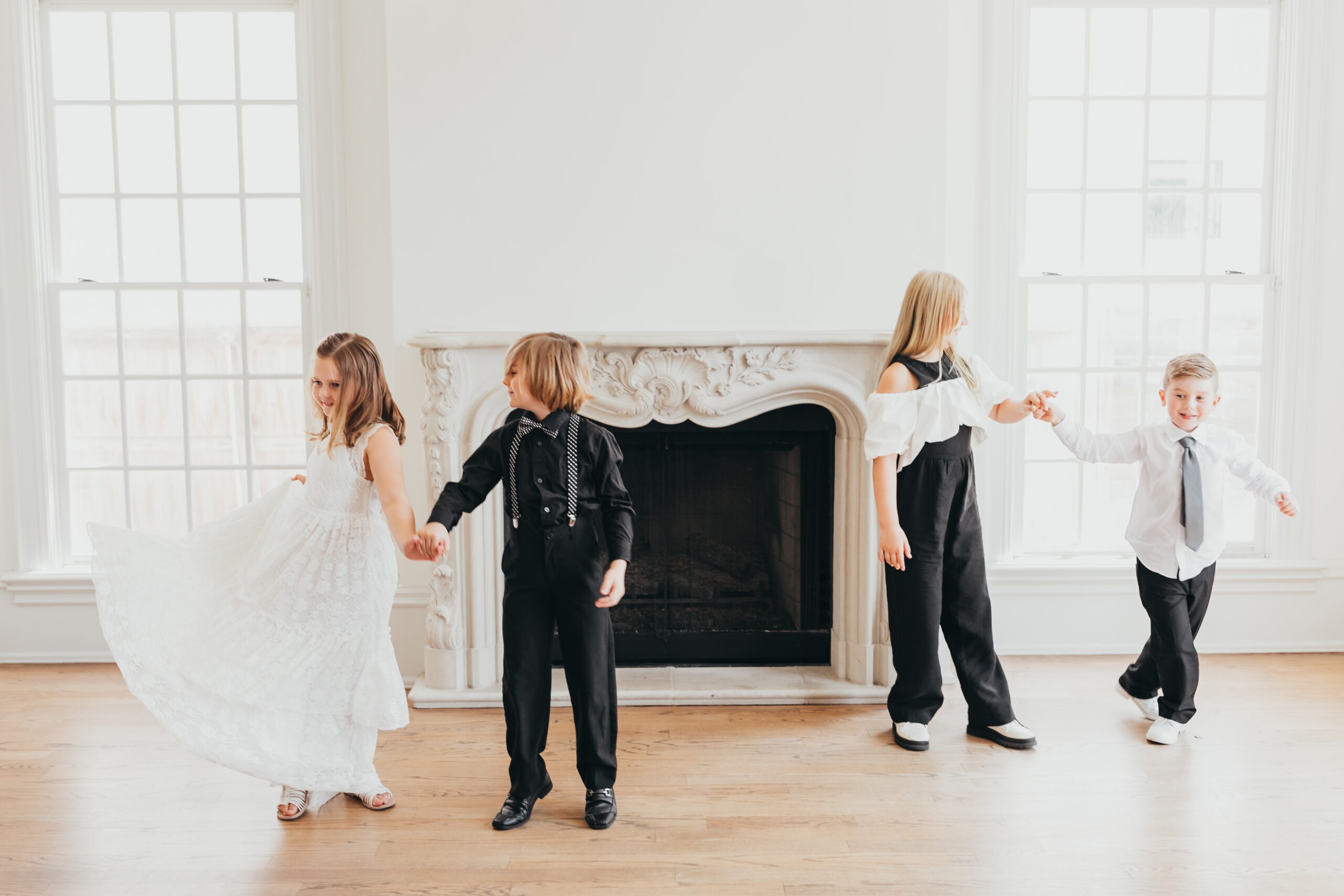 cousins dance in front of mantle at the creative chateau
