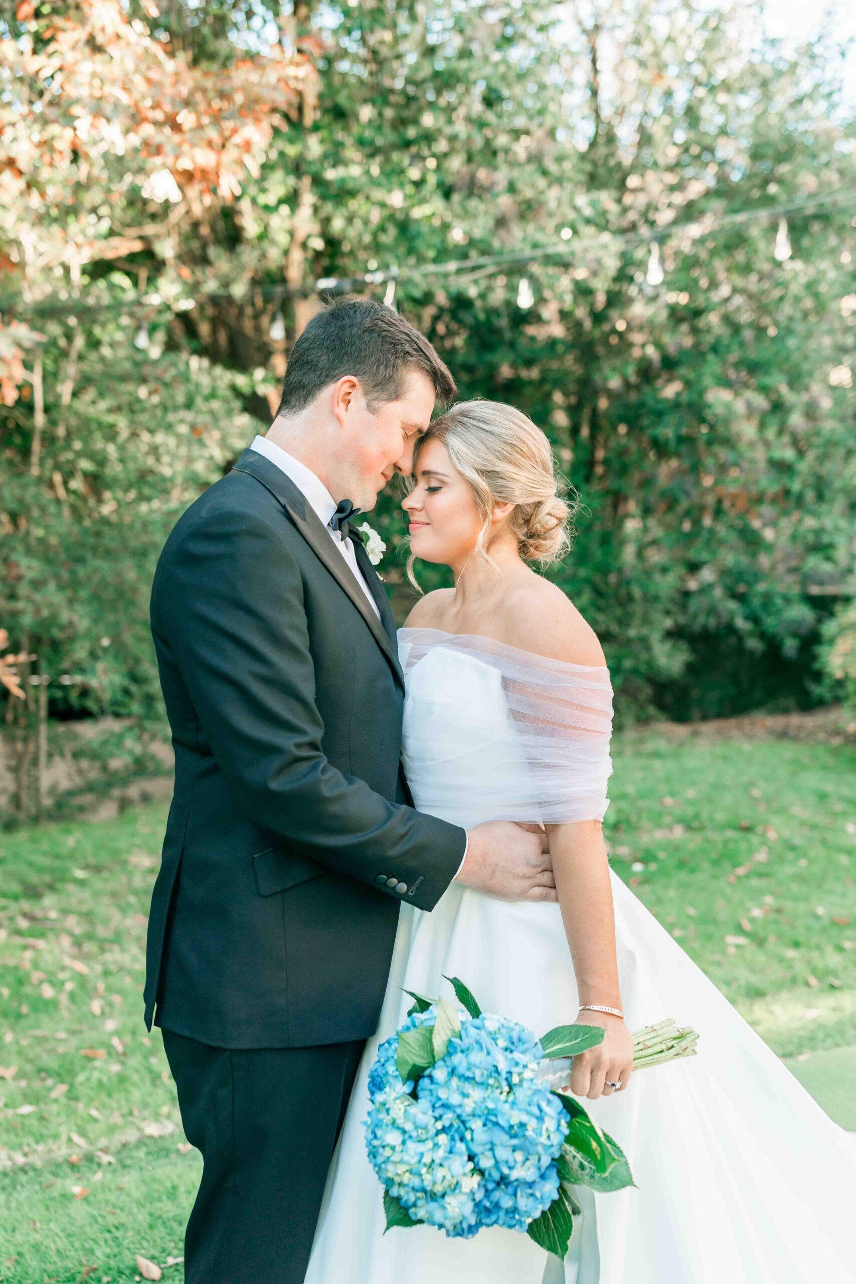 bride and groom snuggle closely on their wedding day.