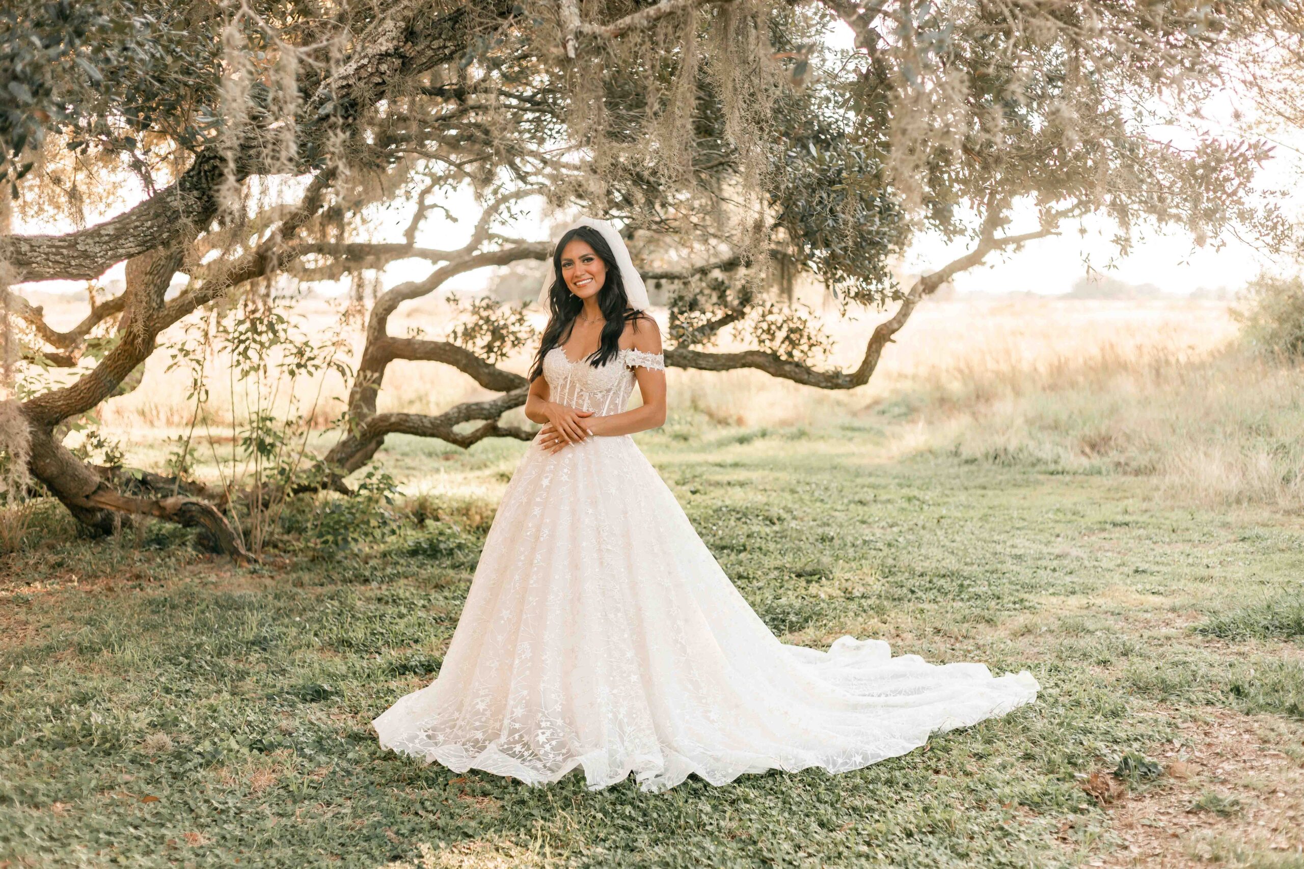 Bride stands in front of mossy trees in Houston Texas for Ally's Photography, wedding photographer